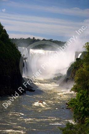 Tour boat beneath waterfalls at Iguazu, Argentina.