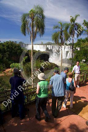 Tourists take photographs of the waterfalls at Iguazu, Argentina.