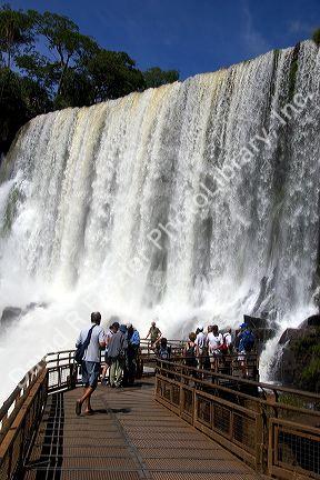 Tourists view waterfalls at Iguazu, Argentina.