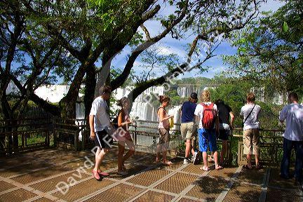 Tourists watch waterfalls at Iguazu, Argentina.