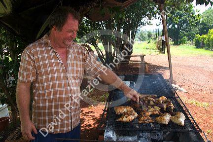 A man grilling chicken in Argentina.