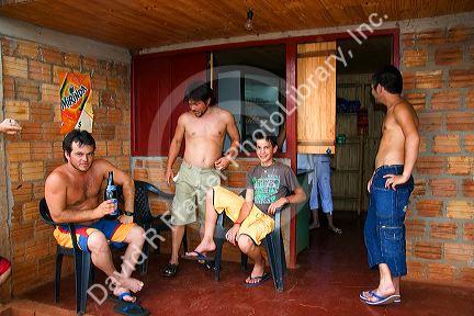People hanging out a bar in Libertad, Argentina.