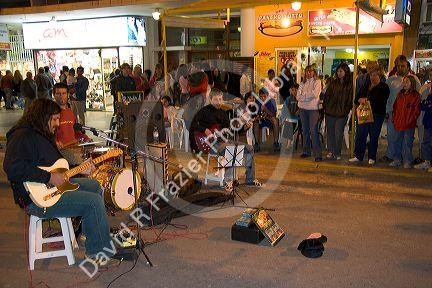 Musicians play instruments on the street in Neccochea, Argentina.