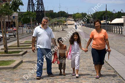 Argentine family walking and holding hands in the La Boca area of Buenos Aires, Argentina.