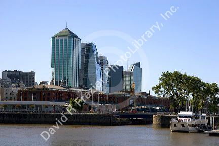 Modern offic buildings tower over the old warehouses of the Puerto Modero area of  Buenos Aires, Argentina.
