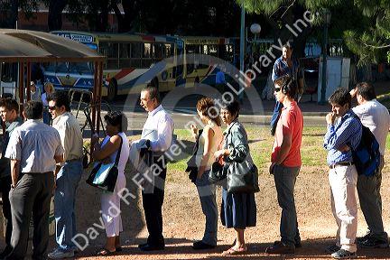 Passengers waiting in line to get on the bus in Buenos Aires, Argentina.