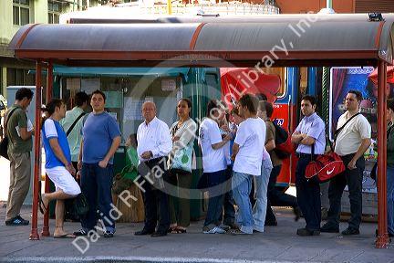 Passengers waiting in line to get on the bus in Buenos Aires, Argentina.