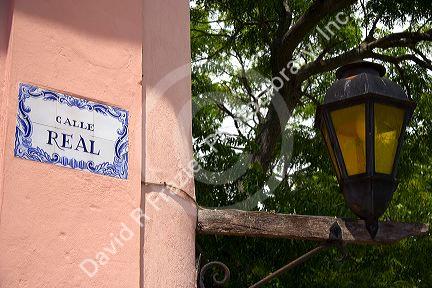 Tile street sign and lamp post in Colonia, Uraguay.