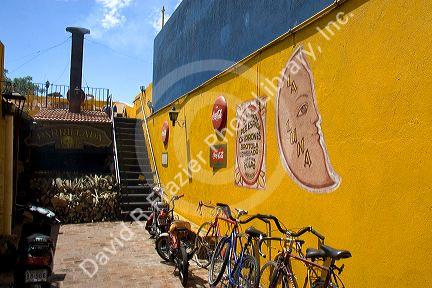 Yellow wall and bicycles at a parrillada restaurant  in Colonia, Uraguay.