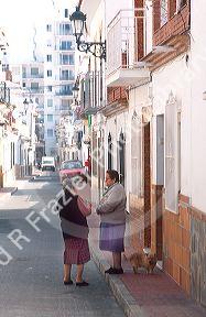 Women talking on the street in Nerja, Spain.