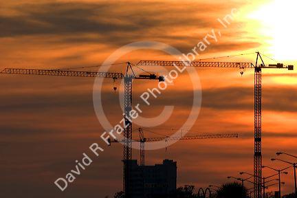 Large construction cranes at sunset in Gulfport, Mississippi.