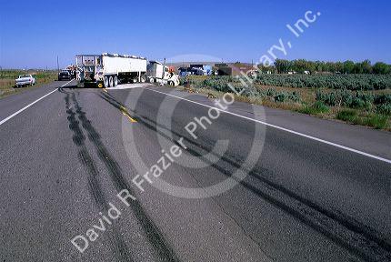 Traffic accident and skid marks from tires on the highway.