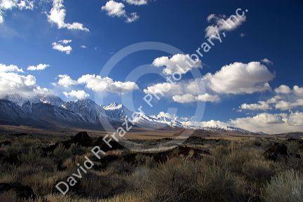 Snow covered Sierra Mountains in the Owens Valley, California with airid desert in foreground.