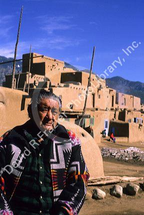 Indian pueblo man and adobe buildings in Taos, New Mexico.