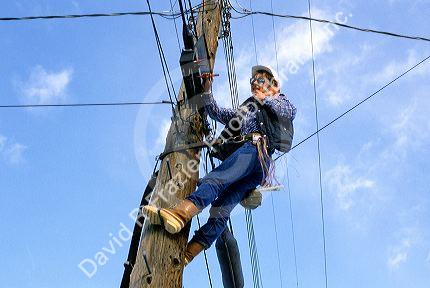 Female telephone lineman making repairs.