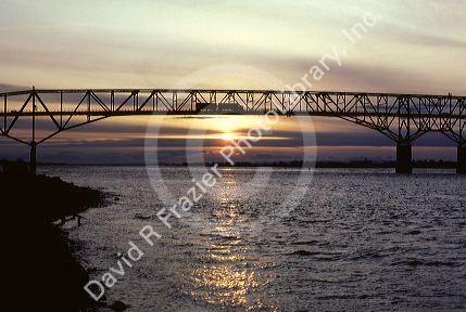 A truck crosses the Umatilla Bridge made of steel trusses over the Columbia River between Oregon and Washington.