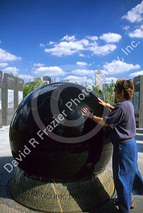 A woman rolling a floating granite ball at the Capitol Mall in Nashville, Tennessee.