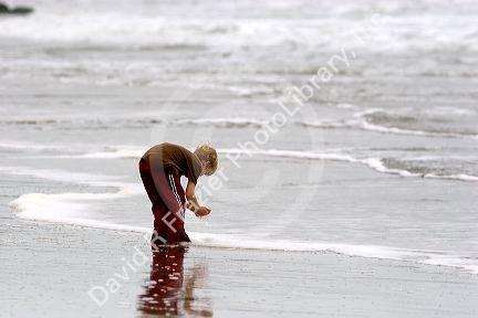 A boy plays in the ocean surf on the beach at Santa Cruz, California.