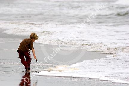 A boy plays in the ocean surf on the beach at Santa Cruz, California.
