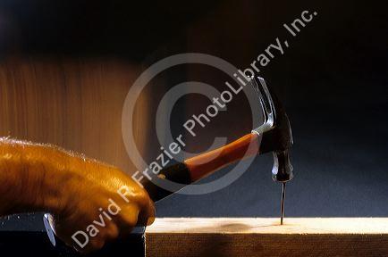 A hammer hitting a nail.