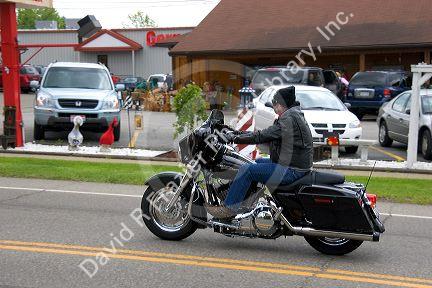 Man riding a motorcycle through Berlin, Ohio.
