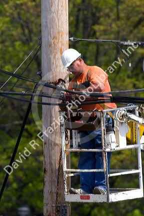 Telephone company lineman working at Hillsdale, Michigan.