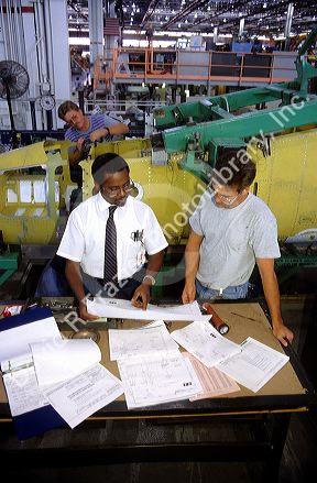 Engineer with worker at Boeing Fighter Aircraft factory. MR