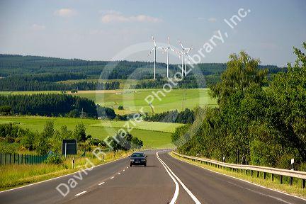 Electricity wind generators and automobiles traveling on the highway in northwest Germany.