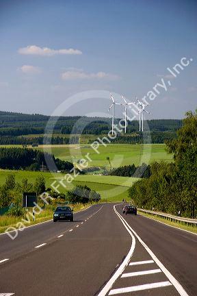 Electricity wind generators and automobiles traveling on the highway in northwest Germany.