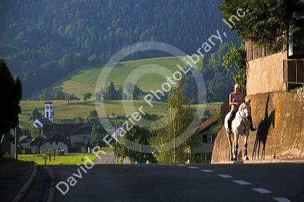 Rider on horseback in village near near Zurich, Switzerland.