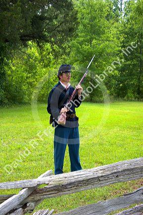 Civil war soldier reenactor and park ranger at Shiloh National Park battlefield, Tennessee.