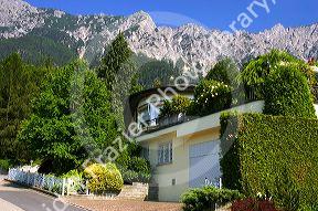 A house in Lichtenstein with the Swiss Alps in the background.