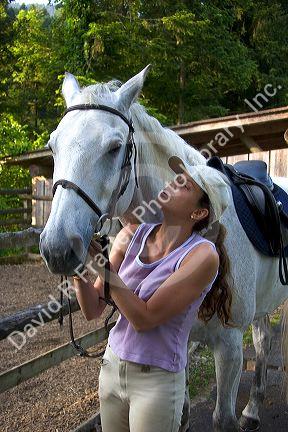 A woman and a horse on a farm near Zurich, Switzerland.
