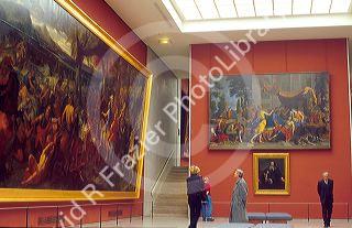 People looking at art in the Lourve. Paris, France.