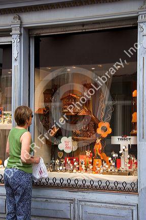 A woman window shopping for watches and clocks in the village of Ribeauville, Eastern France.