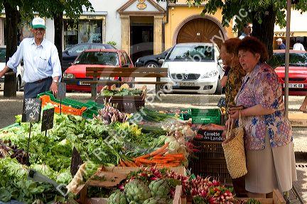 People shop at an open air market in Neuf-Brisach, France.