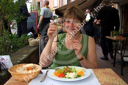 A woman having lunch at a restaurant in the village of Ribeauville, Eastern France.