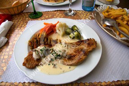 Veal with a cream sauce served at a sidewalk restaurant in Ribeauville, France.