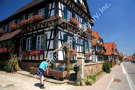 French man pumping water at the village of Betschdorf, France.