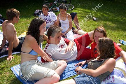 Teens hang out on the banks of Lake Gerardmer, France.