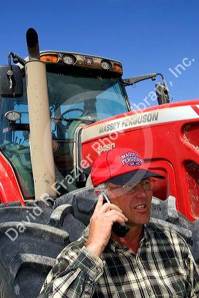 Farmer using a cell phone in the field.