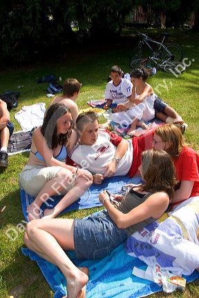Teens hang out on the banks of Lake Gerardmer, France.
