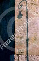 Shadow of street lamp on wall in Verona, Italy.