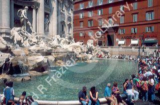 People sitting around Trevi Fountain in Rome, Italy.
