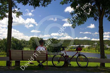 Bicyclist takes a break at Nortre-Dame-Des-Pins south of Quebec City, Quebec, Canada.