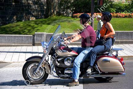 A couple rides a motorcycle in Quebec City, Quebec, Canada.