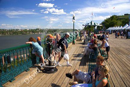 People hang out on the boardwalk in front of the Chateau Frontenac at Quebec City, Quebec, Canada.