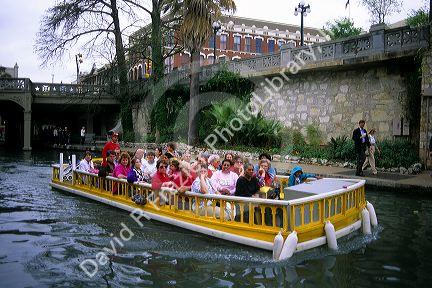 Visitors on a boat tour along the River Walk in San Antonio, Texas.