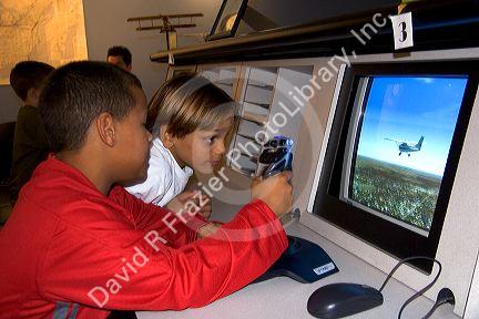 Children use a flight training computer at the McDonnell Planetarium in St. Louis, Missouri.