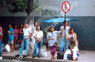 Brazilians people at  bus stop on the streets of Manaus Brazil.